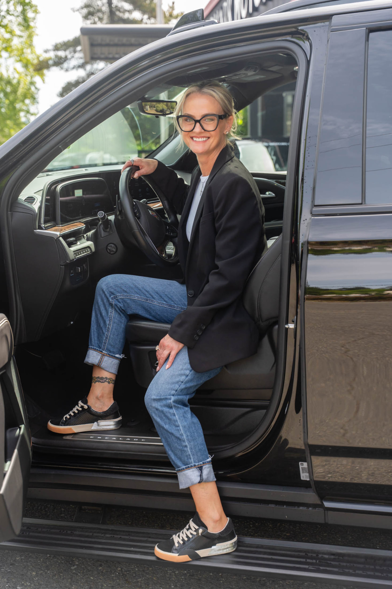 Joli seated in the open doorway of an SUV