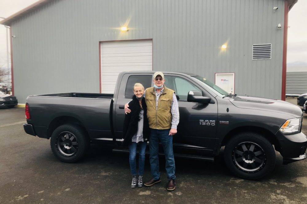 Two couple standing next the pick up truck Two couple standing next the pick up truck