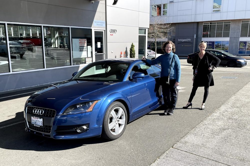 Smiling Ladies Infront of a White Blue Audi Smiling Ladies Infront of a White Blue Audi